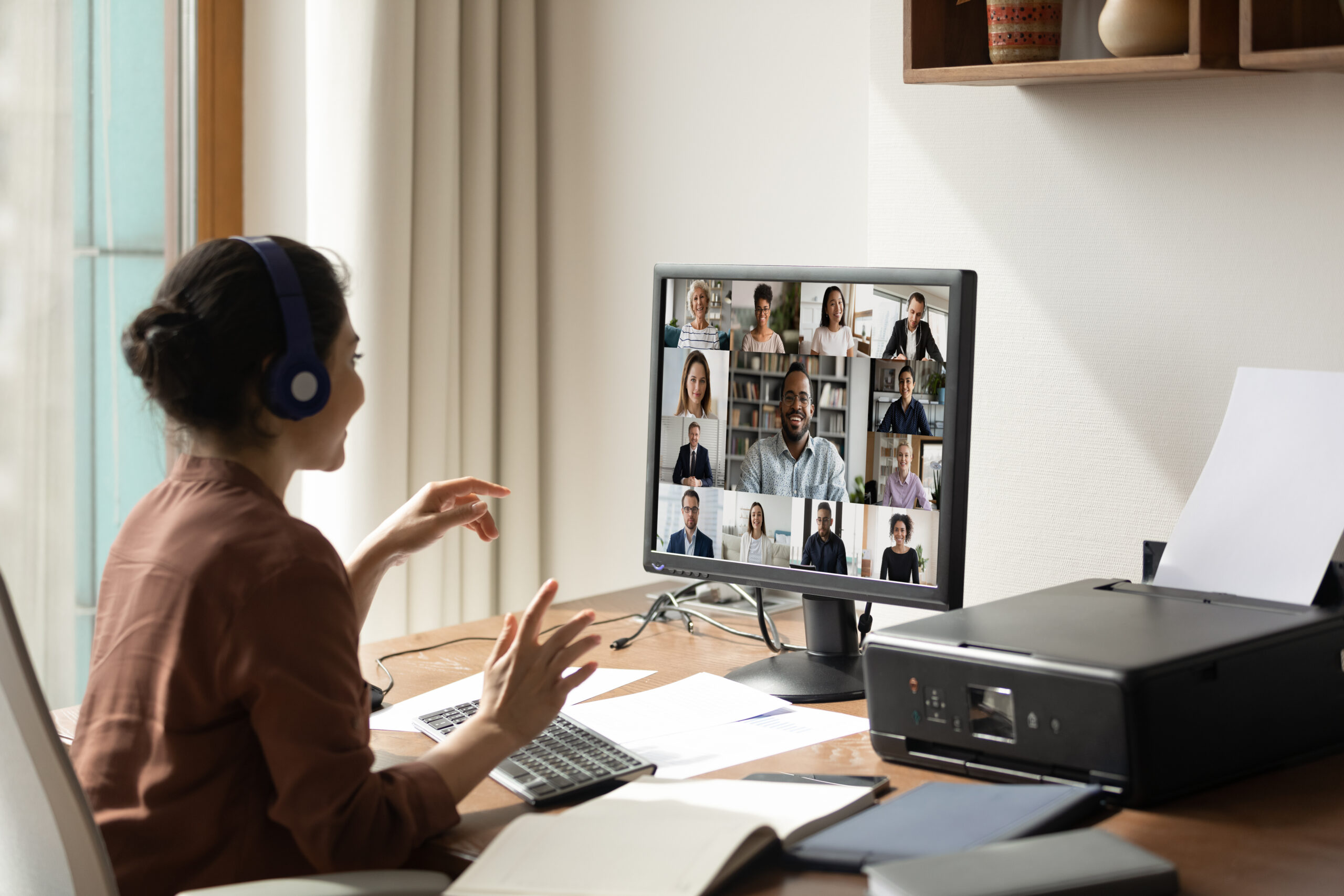 Image of a woman on a video conference call in a home office.