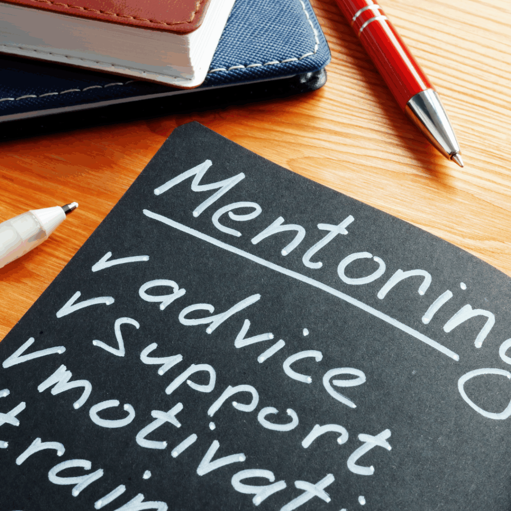 Notes on a desk listing mentoring, advice, support, motivation.
