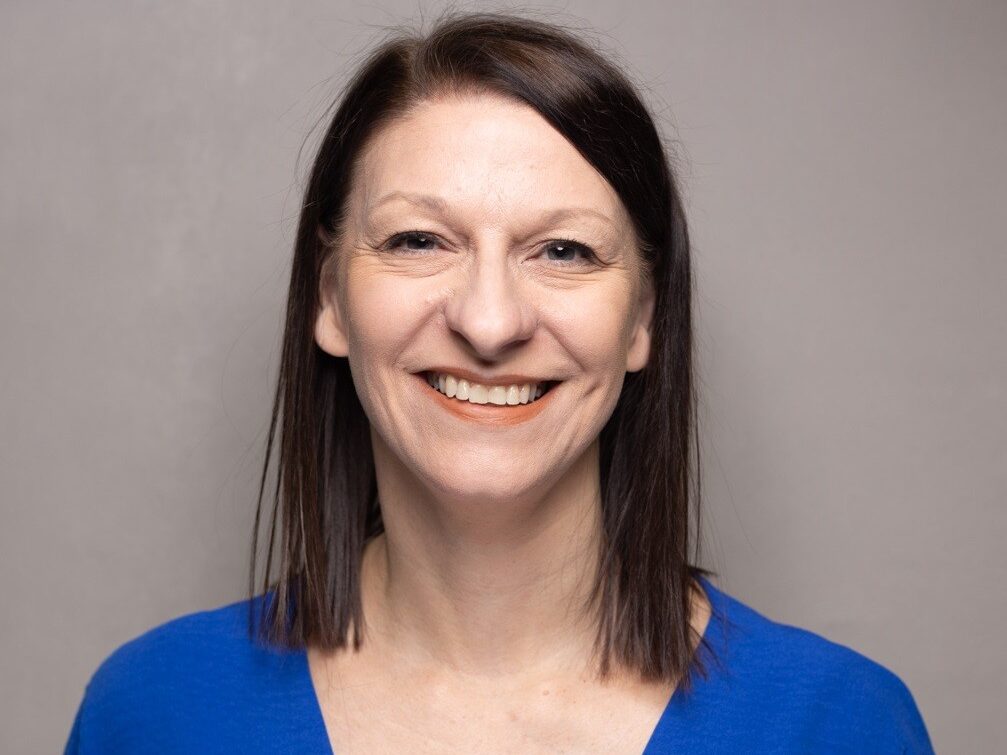 Headshot of Nicola Littler, Director of Workforce at the Pennine Care NHS Foundation Trust, smiling in a blue top
